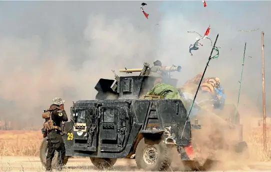  ?? PHOTO: REUTERS ?? An Iraqi special forces soldier fires a cannon at Islamic States fighters in Bartella, east of Mosul.