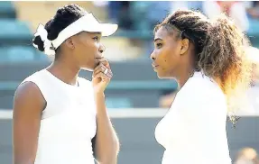  ??  ?? Serena and Venus Williams (left) talk between points in their women’s doubles match against Kristina Barrios of Germany and Stefanie Voegele at Wimbledon 2014.