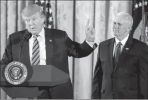  ?? AP/ANDREW HARNIK ?? President Donald Trump, with Vice President Mike Pence, speaks Sunday during a White House senior staff swearing-in ceremony in the East Room of the White House.