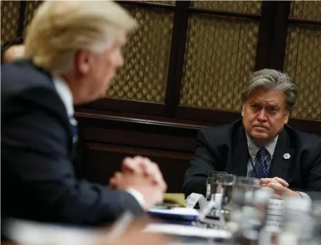  ?? AP ?? Steve Bannon, right, White House chief strategist at the time, in a meeting with US president Donald Trump last January. In a new book, Mr Bannon is quoted saying a meeting between Trump campaign officials and a Russian lawyer was ‘treasonous’