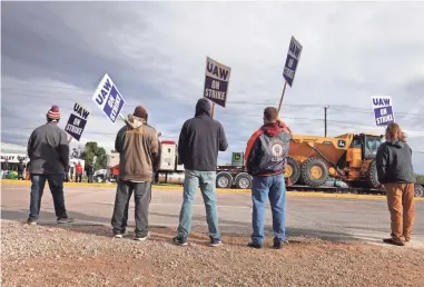  ?? SCOTT OLSON/GETTY IMAGES VIA TNS ?? More than 10,000 John Deere employees, represente­d by the United Auto Workers union, walked off the job Thursday after failing to agree to a new contract with the company.