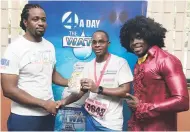  ??  ?? Ahon Gray (centre), winner of the Burpees Challenge, collecting his Active band from Asafa Powell from The Gleaner’s Fit 4 Life fitness coach, Marvin Gordon (left), and fitness coach Kurt Dunn from Body By Kurt.