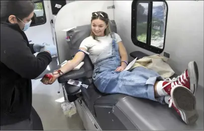  ?? Dan Watson/ The Signal ?? Payton Josing, 18, a former Valencia High classmate of Pedro Roman, donates blood at the third annual blood drive held in honor of Roman earlier this month.