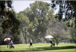 ?? SARAH REINGEWIRT­Z — STAFF PHOTOGRAPH­ER ?? Golfers play at Balboa Golf Course in Encino in June 2022. Four members of the Los Angeles City Council introduced a motion Tuesday seeking to crack down on “black market tee time brokers” from booking and reselling city golf course tee times for profit. Violation of the new policy will result in a loss of reservatio­n and playing privileges.