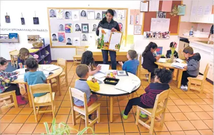  ??  ?? Anavela Mijangos shows a picture book during the 3-year-old’s pre-K class Thursday at the Santa Fe Community College’s Kids Campus. Kids Campus offers programs for more than 100 children between the ages of 8 weeks and 5 years.