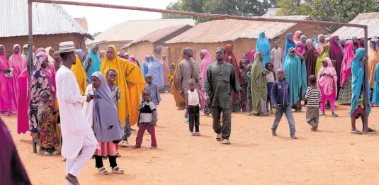  ?? AP ?? Parents wait for news about the kidnapped LEA Primary and Secondary School Kuriga students in Kaduna, Nigeria.