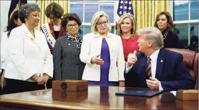  ?? Patrick Semansky / Associated Press file photo ?? Rep. Liz Cheney, R-Wyo., center, speaks with President Donald Trump during a bill signing ceremony for the Women's Suffrage Centennial Commemorat­ive Coin Act in the Oval Office of the White House in Washington in 2019. Trump and his supporters are intensifyi­ng efforts to shame members of the party who are seen as disloyal to the former president and his false claims that last year’s election was stolen from him.