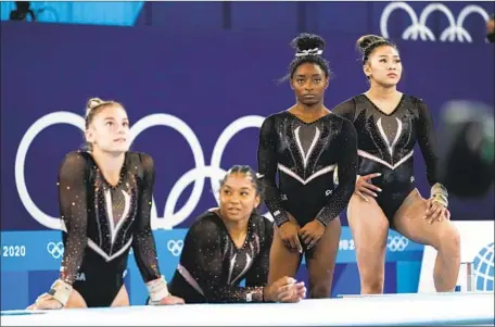  ?? Photograph­s by Ashley Landis Associated Press ?? WAITING THEIR turn on the vault are, from left, Grace McCallum, incoming UCLA freshman Jordan Chiles, Simone Biles and Sunisa Lee, an 18-year-old who could team with the heavily favored Biles to finish 1-2 in the all-around event. Team qualifying is Sunday.