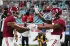  ?? CHRIS O’MEARA — THE ASSOCIATED PRESS ?? Alabama wide receiver John Metchie III, left, congratula­tes wide receiver DeVonta Smith, after Smith scored a touchdown against Ohio State during the first half of the College Football Playoff championsh­ip game, Monday, in Miami Gardens, Fla.