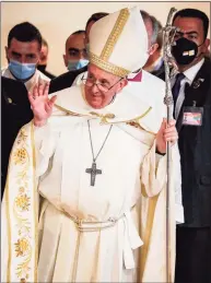  ?? Sabah Arar / AFP via Getty Images ?? Pope Francis arrives at Baghdad's Saint Joseph Cathedral on the second day of the first papal visit to Iraq on Saturday. Pope Francis made a plea for peace, telling those gathered at an interrelig­ious service in southern Iraq that he hoped the world would “journey from conflict to unity.”