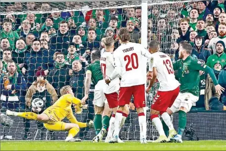  ?? LORRAINE O’SULLIVAN/AFP ?? Republic of Ireland defender Matt Doherty (right) watches his header beat Denmark goalkeeper Kasper Schmeichel to level the sores during the Group D Euro 2020 qualificat­ion match at Aviva Stadium in Dublin on Monday.