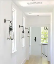  ?? PHOTOS: KATHERINE FREY/WASHINGTON POST ?? Hurricane lanterns line a hallway. “Vintage fixtures give texture to a home,” Zantzinger says.