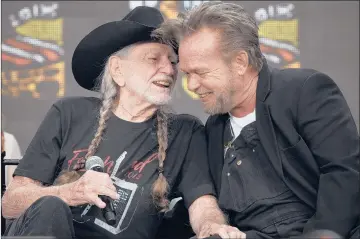  ?? MELANIE STENGEL | SPECIAL TO THE COURANT ?? WILLIE NELSON, left, shares a word with John Mellencamp during a press conference at the beginning of Farm Aid 2018 on Saturday at Hartford’s Xfinity Theatre. Nelson, Mellencamp and Neil Young performed and advocated for farmers at the annual concert series.
