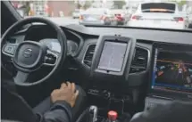  ??  ?? An Uber driverless car waits in traffic during a test drive in San Francisco. The ride-sharing company pulled the cars off roads Wednesday. California demanded it get a special permit before using public roads. Eric Risberg, The Associated Press