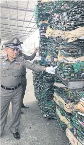  ??  ?? SO WHAT’S THIS THEN: Deputy national police chief Wirachai Songmetta checks on a pile of electronic waste at a plant in Chachoengs­ao.