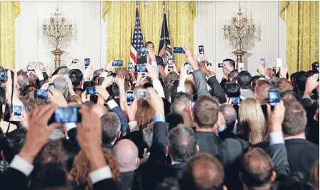  ?? Photo: REUTERS ?? Connected: Guests at a White House function use their phones to photograph and video President Barack Obama. The use of smartphone­s is exploding around the world.