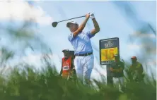  ?? Andy Buchanan / AFP via Getty Images ?? Collin Morikawa tees off on 15 during his secondroun­d 64.