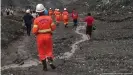  ??  ?? Rescue workers search for survivors after a landslide in Kachin state