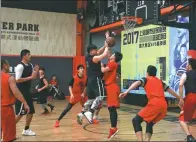  ?? PROVIDED TO CHINA DAILY ?? Local residents compete in the basketball tournament of the Shanghai Amateur Games as the city aims to inspire people to get involved in sports.
