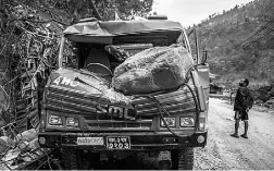  ?? PHILIPPE LOPEZ / AFP / Gett y Images ?? A truck sits crushed by a rock in rural Melamchi, Nepal.