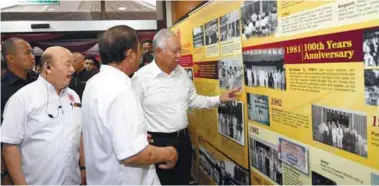  ??  ?? Najib looking at an exhibit during his vist to Tung Shin Hospital yesterday.