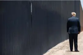  ??  ?? BORDER FILLED IN: President Trump checks out a segment of border wall during a visit to Arizona this week.