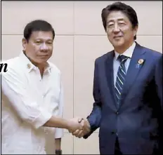  ??  ?? FAMOUS IN JAPAN: President Duterte and Japanese Prime Minister Shinzo Abe shake hands at the start of their meeting on the sidelines of the ASEAN Summit in Laos yesterday. Abe told Duterte he was famous in Japan and was excited to meet him.