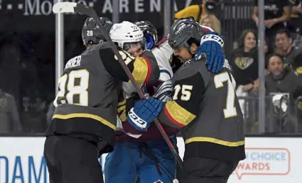  ?? RJ Sangosti, The Denver Post ?? Colorado left wing Andre Burakovsky is in the middle of Vegas left wing William Carrier (28) and right wing Ryan Reaves (75) during Sunday night’s game at T-Mobile Arena.