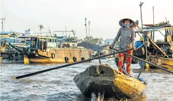  ?? Picture: 123rf.com/_jeffcaglep­hoto ?? STICK WITH IT A merchant paddles through Cai Rang Floating Market in Can Tho in the Mekong Delta.