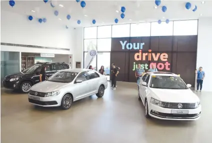  ?? SUNSTAR FOTO / RUEL ROSELLO ?? NEW MODELS. the Volkswagen Tiguan, Santana and Lavida can be viewed at the Volkswagen Cebu showroom. Sales manager Harlan Dean says they hope to sell 300 units this year.