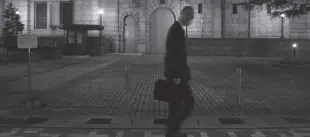  ?? Bloomberg News ?? This October 26, 2022, photo shows a man walking past the Bank of Japan headquarte­rs at dusk in Tokyo, Japan.