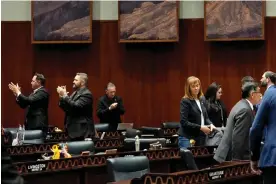  ?? Arizona. Photograph: Matt York/AP ?? Representa­tives applaud after blocking another effort to repeal the ban, on 17 April 2024 in Phoenix,