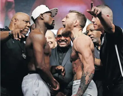  ?? JOHN LOCHER/THE ASSOCIATED PRESS ?? Floyd Mayweather Jr., left, and UFC star Conor McGregor both made weight Friday in Las Vegas, meaning the boxing fight (farce?) everyone is anticipati­ng will go ahead as planned Saturday, when millions will be watching and millions of dollars will be...