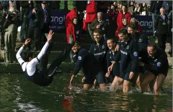  ?? TOM HEVEZI — THE ASSOCIATED PRESS FILE ?? The Oxford crew, right, throw their cox Colin Groshong into the Thames at the 155th Boat Race, in London, Sunday March 29, 2009. Jumping into London’s River Thames has been the customary celebratio­n for members of the winning crew in the annual Boat Race between storied English universiti­es Oxford and Cambridge. Now researcher­s say it comes with a health warning.