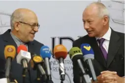  ?? ATTA KENARE/AFP/GETTY IMAGES ?? Iranian Minister of Industry Mohammad Reza Nematzadeh, left, and Renault’s Thierry Bolloré announced a deal to produce up to 150,000 additional cars a year.