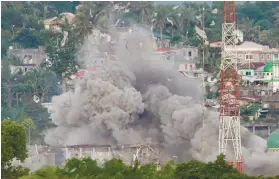  ?? AP FILE FOTO ?? AIRSTRIKE. In this June 9, 2017 file photo, debris and smoke rise after a Philippine Air Force fighter jets bombed suspected locations of Muslim militants, in Marawi City. The siege prompted President Rodrigo Duterte to place Mindanao under martial law.