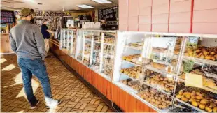  ?? Justin Katigbak/Speical to The Chronicle ?? Chuck’s Donuts on Woodside Road is an old-school, 24-hour temple for doughnut lovers.