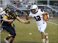  ?? AUSTIN HERTZOG — MEDIANEWS GROUP ?? Boyertown quarterbac­k Anthony Panarello (12) rushes to the outside as Upper Perkiomen’s Damon Faraco closes in during their game on Aug. 27.