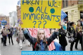  ??  ?? MANCHESTER: A protestor holds up a placard during an anti-Brexit march on the first day of the Conservati­ve Party annual conference yesterday. — AFP