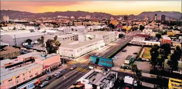  ?? CoStar ?? A MODEL depicts a campus, center, being built at 817 Vine St. where Netflix will rent 100,000 square feet.