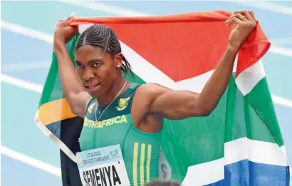  ?? AFP ?? south-africa’s caster semenya celebrates with her national flag after winning the women’s 800m of the african championsh­ips. —