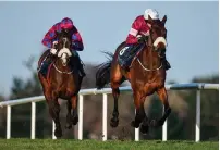  ??  ?? Shattered Love, with Mark Walsh up (right), gets the better of Jury Duty (Robbie Power) to win the Neville Hotels Novice Steeplecha­se