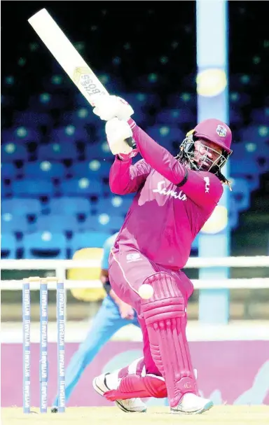  ?? FILE ?? West Indies opening batsman Chris Gayle hit a four during the third one-day internatio­nal cricket match against India in Port of Spain, Trinidad, yesterday.