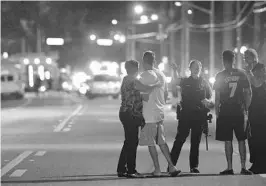  ?? PHELAN M. EBENHACK/ASSOCIATED PRESS ?? Orlando Police officers direct worried family members away from the area after the mass shooting at the Pulse nightclub early Sunday, June 12, 2016.