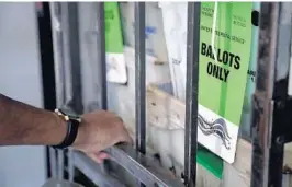  ?? AMY BETH BENNETT/SOUTH FLORIDA SUN SENTINEL ?? Hubert Patrick pulls a rack full of vote-by-mail ballots to be loaded onto a truck at the Broward County Voter Equipment Center in Lauderhill on July 9.