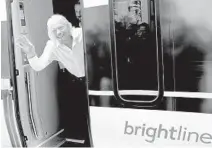  ?? LYNNE SLADKY/AP ?? Richard Branson, of Virgin Group, waves as he arrives on a Brightline train last April in West Palm Beach. The regional high-speed train line, which is extending its system to Orlando, is being renamed Virgin Trains USA while it invites proposals from other South Florida cities to jump aboard.