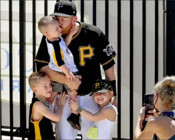  ?? Matt Freed/Post-Gazette ?? Time for a family picture at LECOM Park. Jackie Frazier takes the shot as husband and Dad Todd holds son Grant, 2, while Blake, 6, left, and Kylie, 5, are all smiles for Mom.