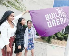  ?? NICK BRANCACCIO ?? Nour Hachem, left, Vanessa Vu, 13, and her sister Vanna Vu, 14, join a flag-raising ceremony during Internatio­nal Day of the Girl and City of Windsor’s Dreamer Day at city hall Thursday.