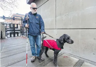  ??  ?? Brian Frank is worried about how his guide dog, Cody, will function if he’s afraid of traffic.