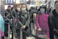  ?? FRAM DINSHAW/ TRURO NEWS ?? These travellers waiting in line to check in at Heathrow Airport in London were just some of the thousands scrambling to return home on March 16. They were leaving the United Kingdom as countries around the world closed their borders and restricted air travel in a bid to stop COVID-19’S spread.